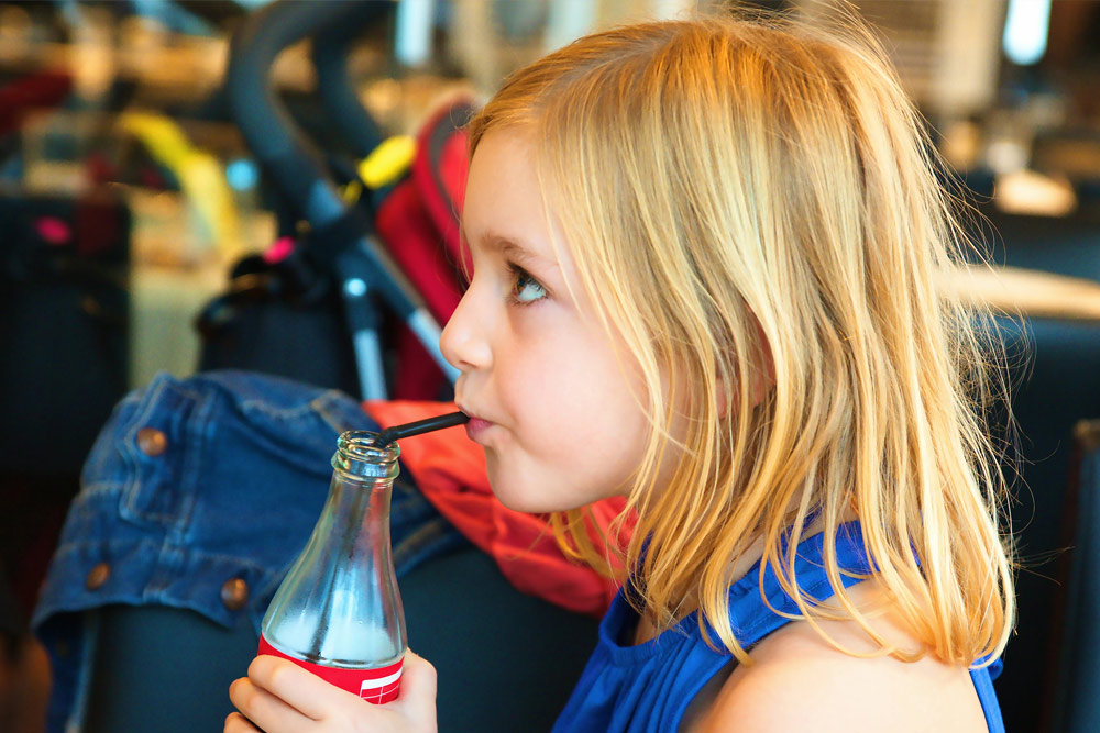Young girl drinking soft drink | Dental health